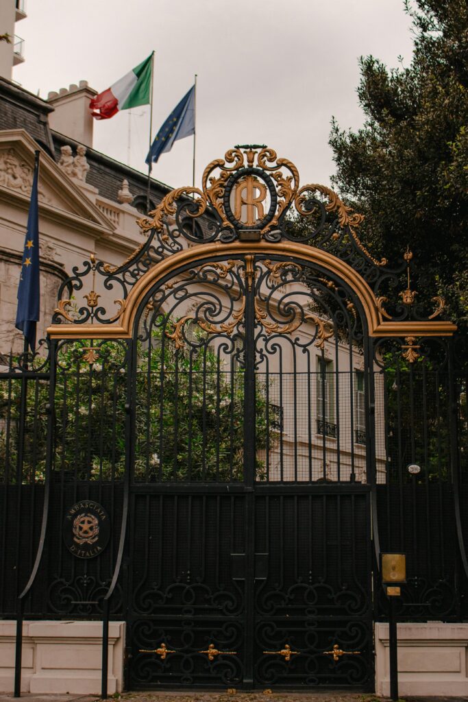 Decorative wrought iron gate with flags at an embassy in Buenos Aires, Argentina.